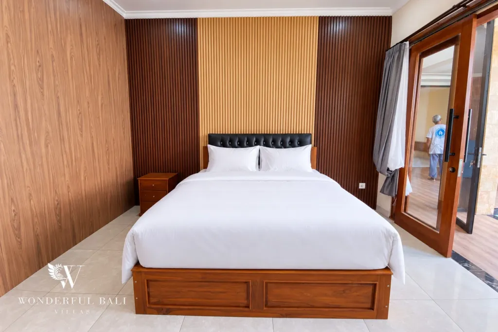 3BR villa for sale or rent in Sanur — second bedroom with timber wall and terrace door
