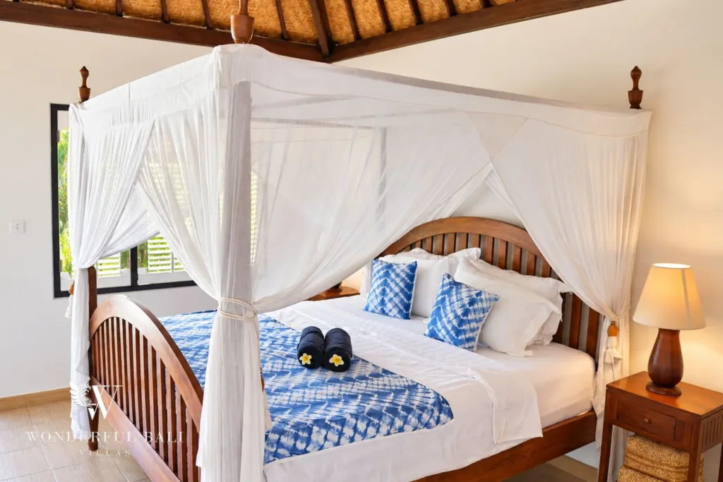 3BR villa for rent in Tabanan — four-poster bed under a timber and alang-alang ceiling