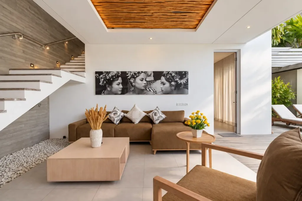 Villa Swan 02 — living, olive sofa and timber coffee table under a large black-and-white portrait