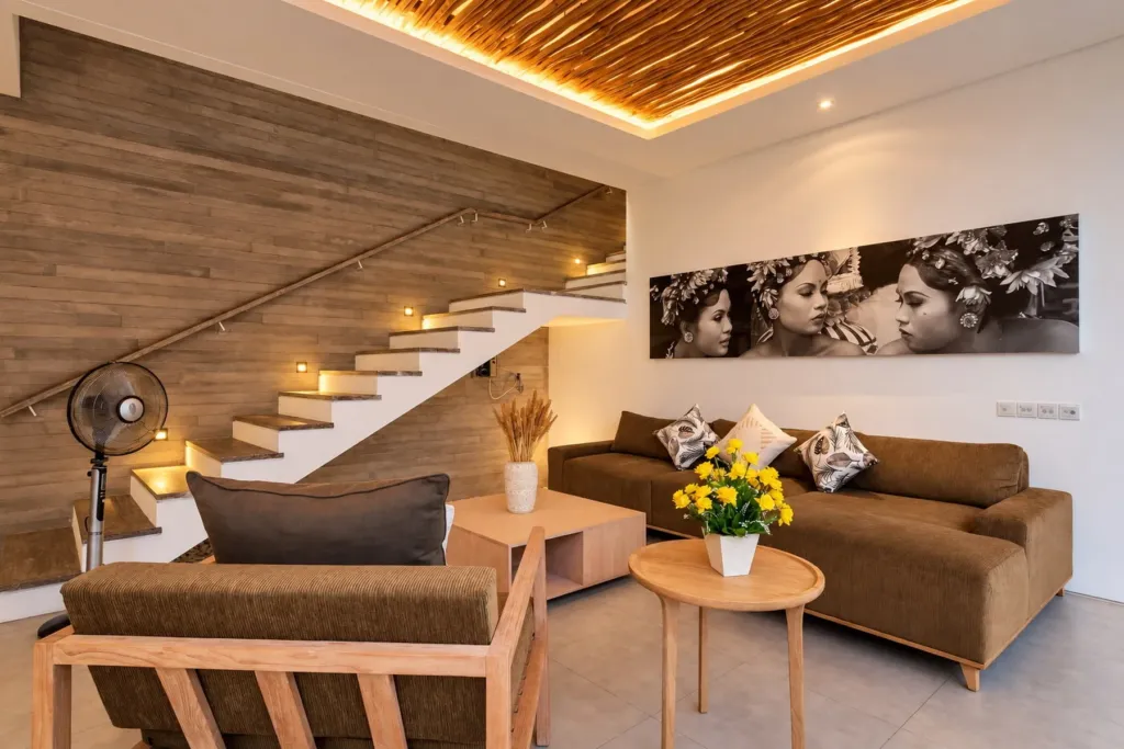 Villa Swan 02 — living, sectional sofa, rattan armchair and timber stair lit by warm cove lighting