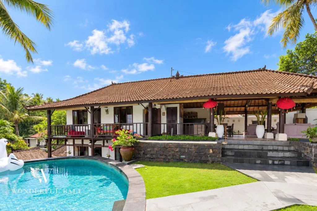 3BR villa for rent in Tabanan — pool and lawn in front of the tiled-roof living pavilion
