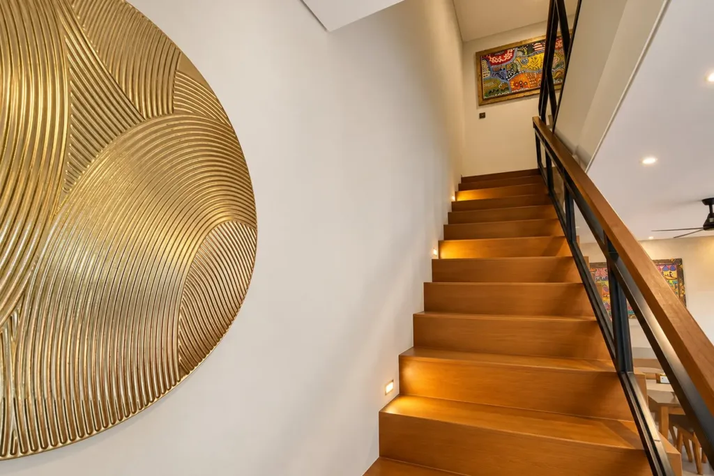 3BR villa for rent in Sanur — teak staircase with step lights and gold wall art