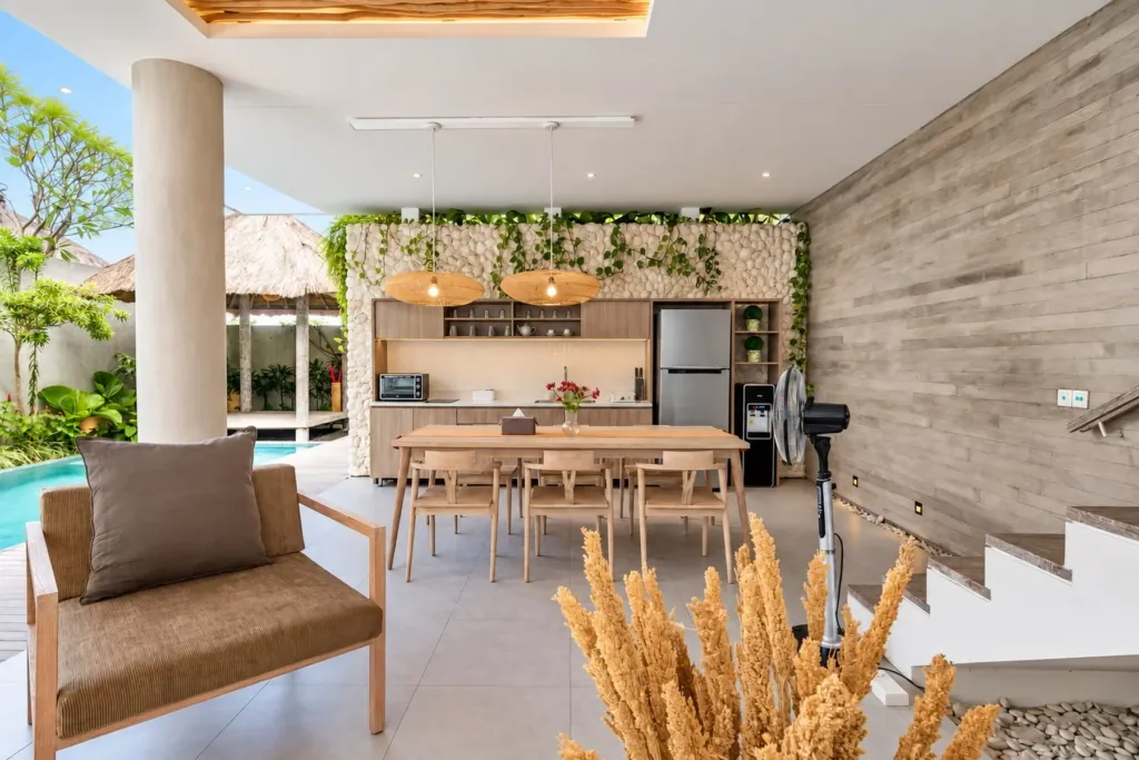 Villa Swan 02 — dining, table and kitchen against a stacked stone wall with dried pampas