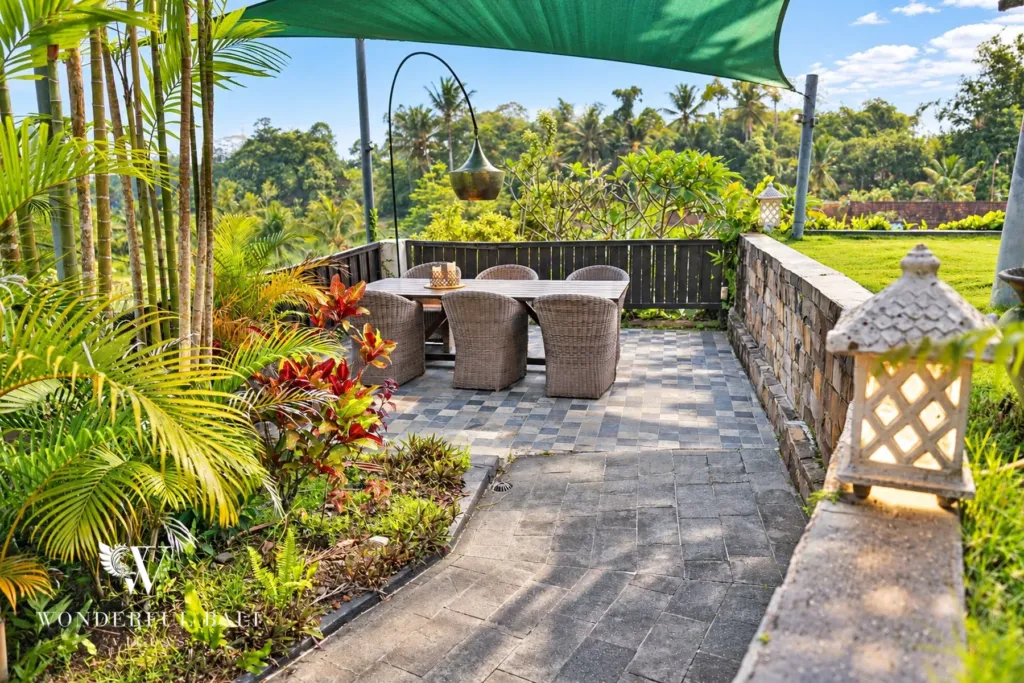 3BR villa for rent in Tabanan — paved garden terrace with dining table above the rice fields