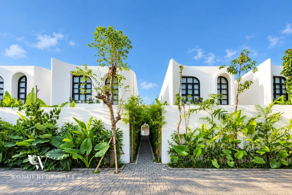 2BR villa for rent in Munggu — landscaped entrance between white villas