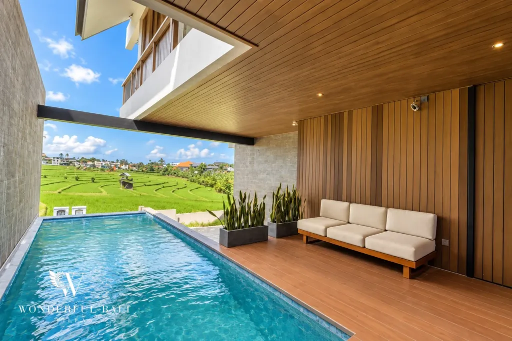 3BR villa long term rental Canggu — poolside lounge facing the rice fields