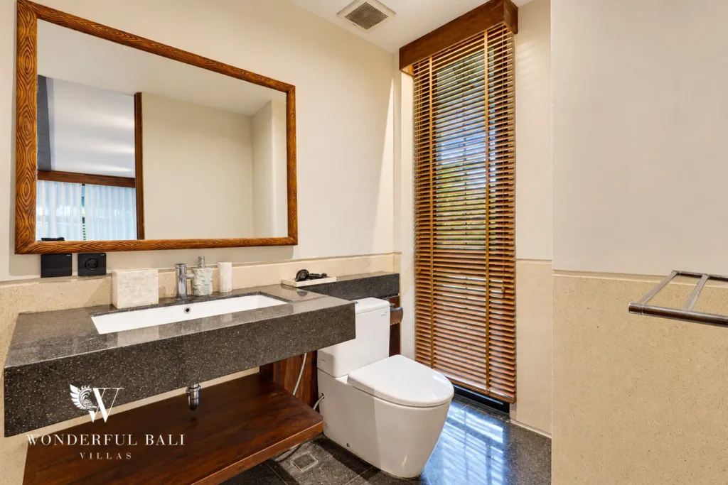 4BR villa for sale in Canggu — stone vanity and timber-framed mirror