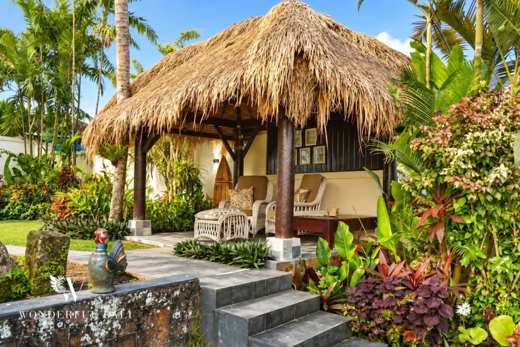 3BR villa for rent in Tabanan — thatched garden gazebo with seating among tropical plants