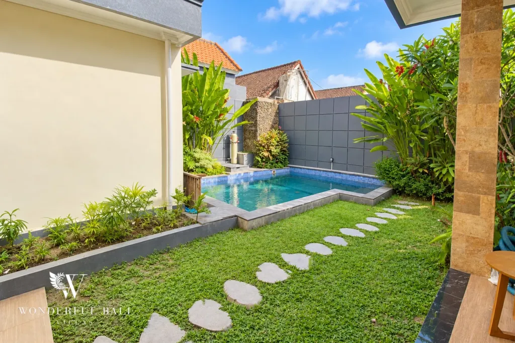 3BR villa for sale or rent in Sanur — lawn and pool along the side of the villa