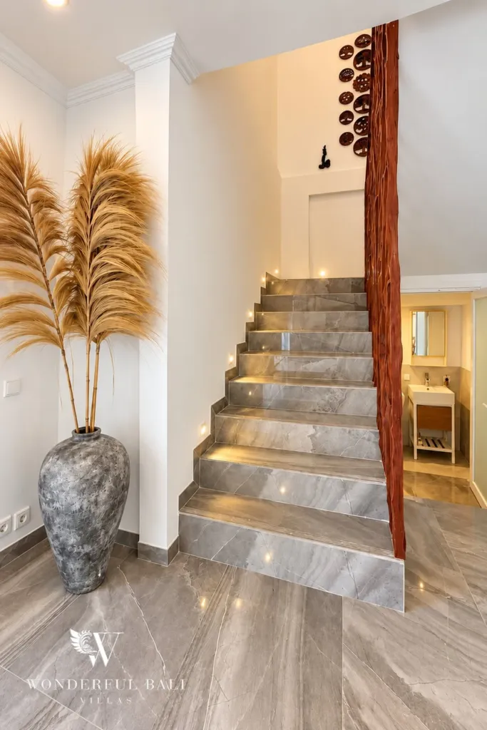 3BR villa for rent in Padonan — lit stone staircase to the upper floor