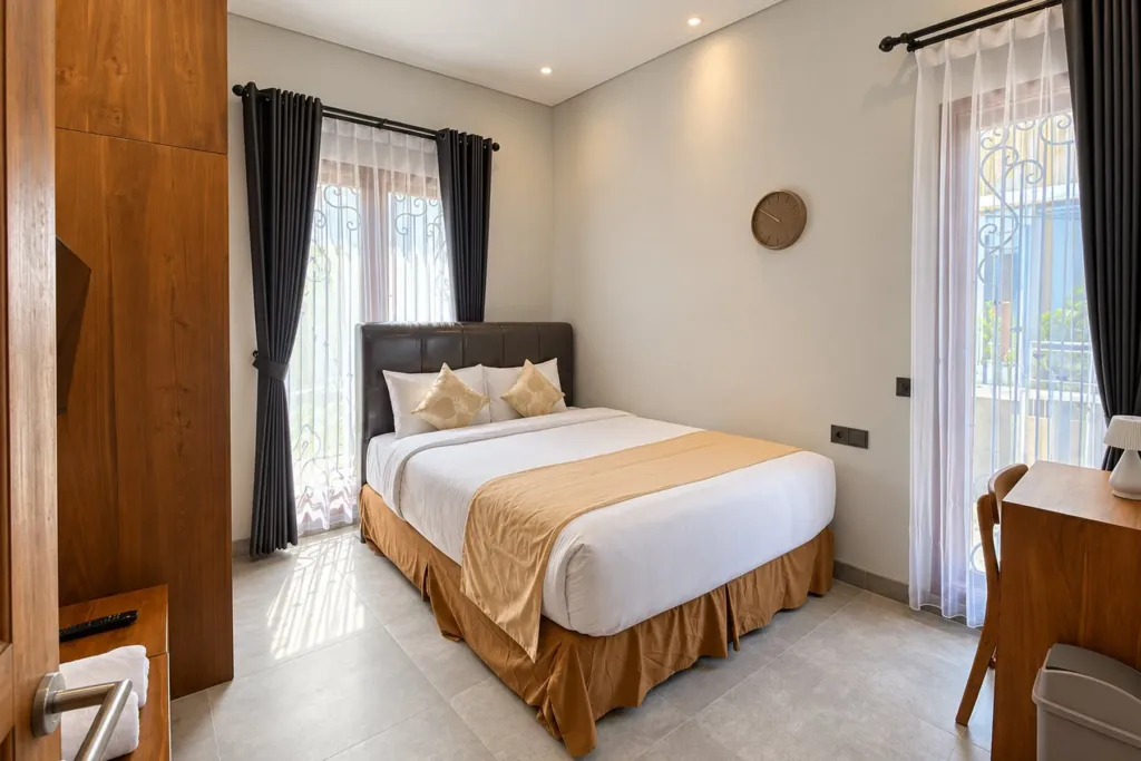 3BR villa for rent in Sanur — third bedroom with leather headboard and French window