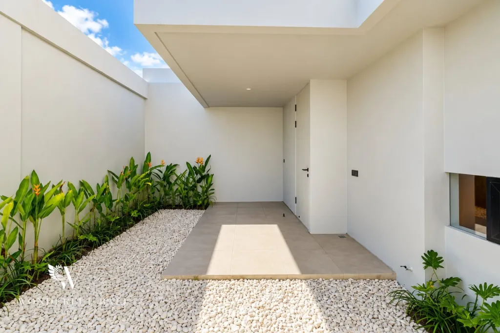 3BR villa long term rental Canggu — entrance courtyard with tropical planting