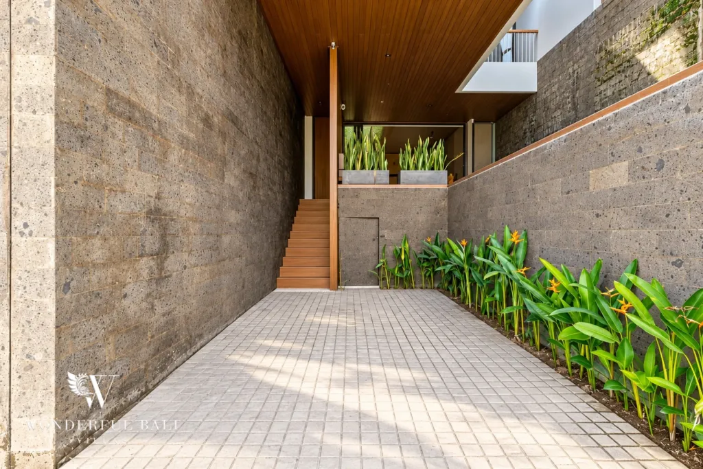 3BR villa long term rental Canggu — stone-walled entrance walkway