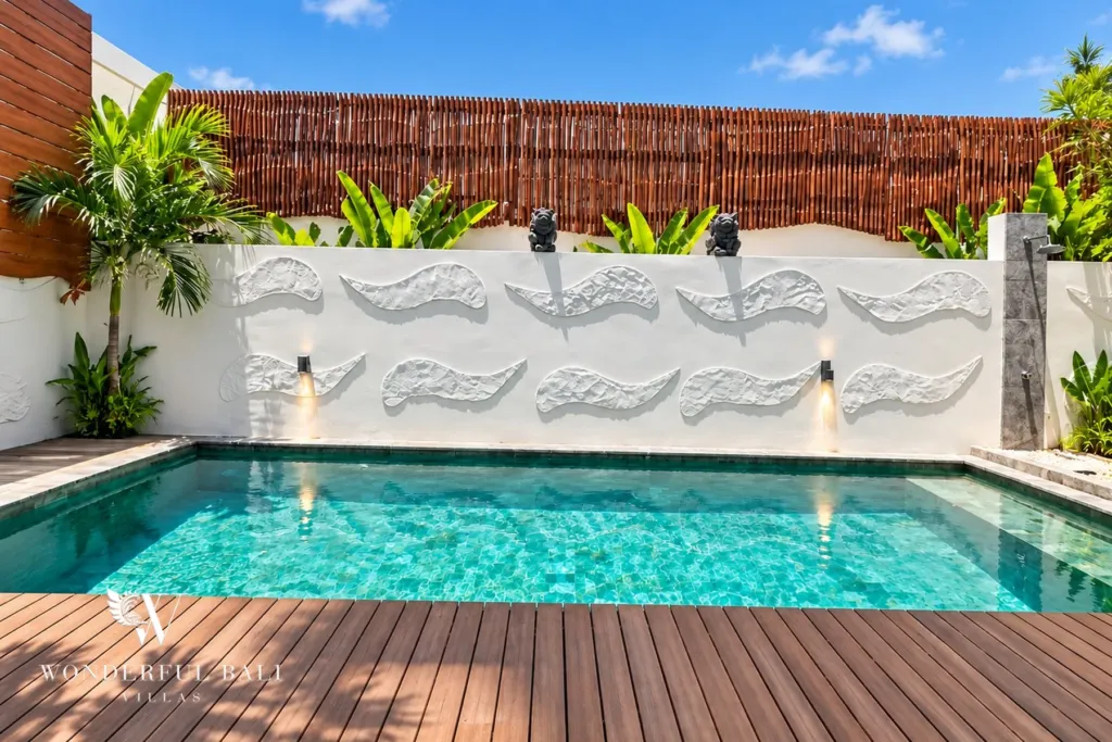 3BR villa for rent in Padonan — pool beside a sculpted white feature wall