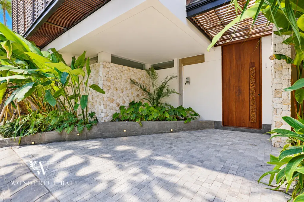 4BR villa for sale in Canggu — timber front door beside the parking court