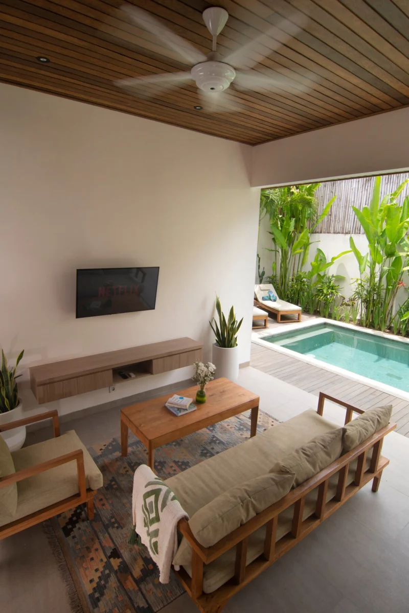 Villa LaBumbak, Umalas — living, sofa and coffee table facing the TV, window onto the pool and planting