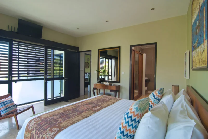 The bedroom with small balcony and pool view.