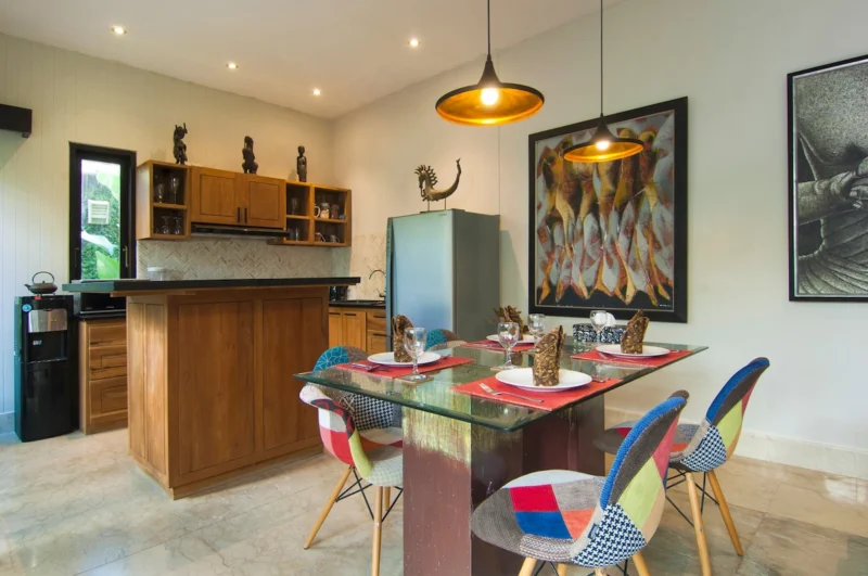 Dining area with open kitchen at Villa Casaneo Bali.
