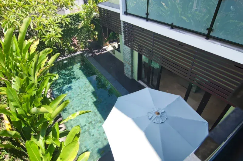 Pool terrace with sun loungers at Villa Casaneo in Seminyak Bali.