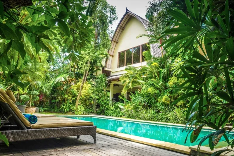 Private tropical garden and swimming pool at Villa Bali Maja in Petitenget, Bali.