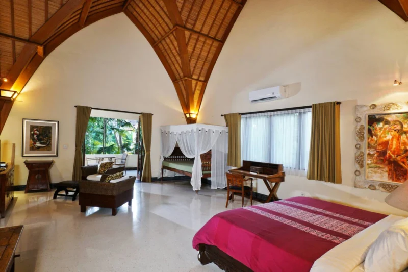 the bedroom upstairs with extra bed and seating area