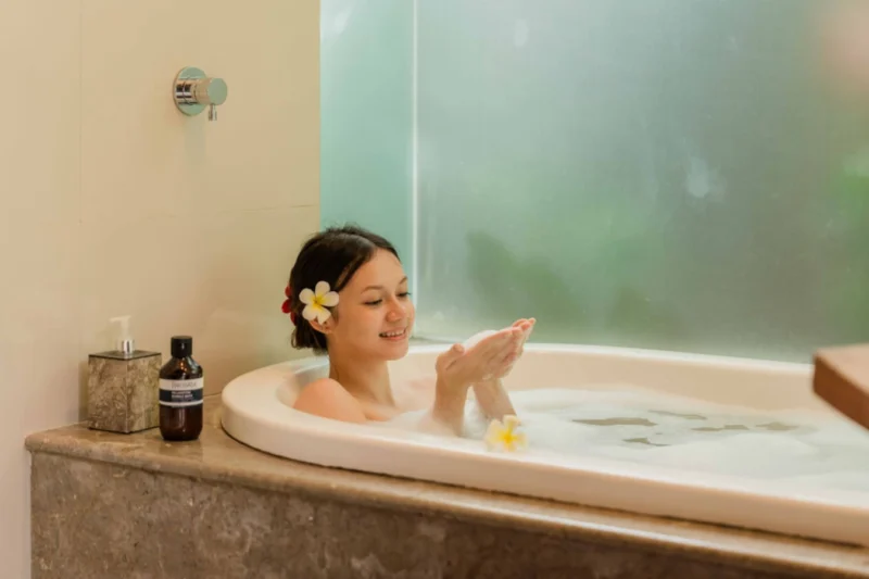The soaking tub is deep, private, and positioned beside the frosted garden wall — enough natural light and tropical air to feel completely Balinese, enough enclosure to completely switch off. One of the better ways to end a Bali day.