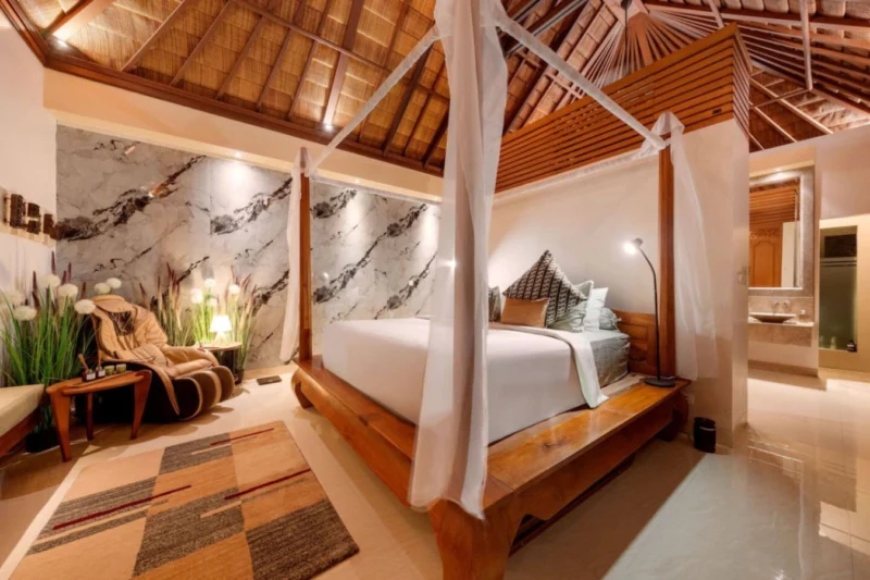 Designed to be the first thing you see in the morning and the last at night. The four-poster canopy bed, the dramatically veined marble wall, and warm architectural lighting make this a bedroom you don't just sleep in — you stay in.